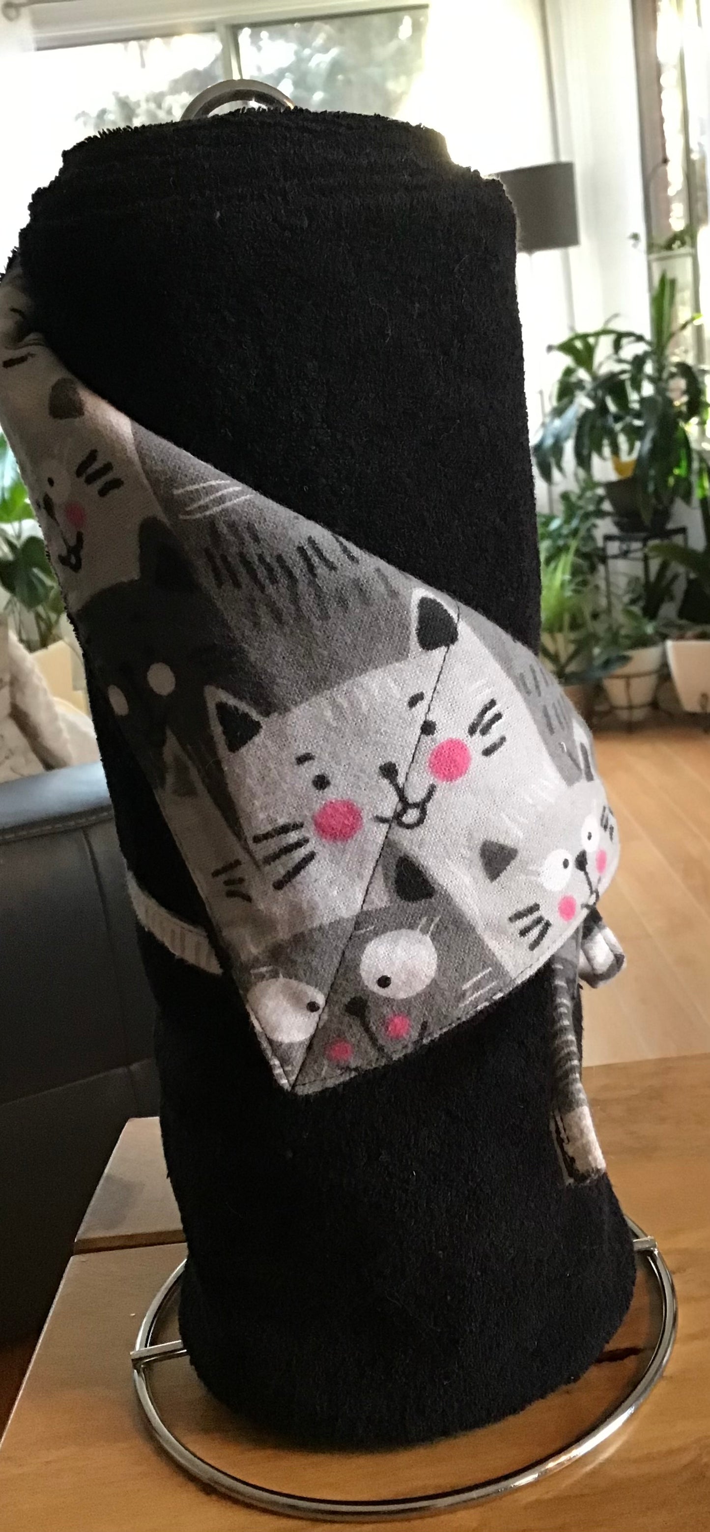 Black flannel and terry paper towel roll with cats.